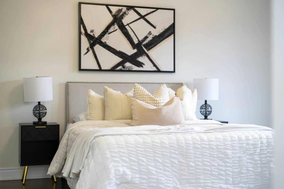 industrial style bedroom ideas featuring reclaimed wood bed frame and black metal pendant lights