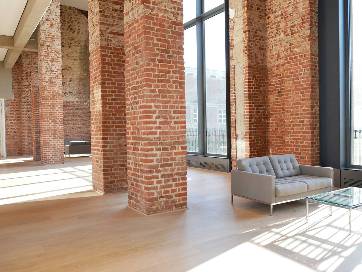 urban industrial nw furniture featuring a reclaimed wood dining table with black steel legs in a sunlit Seattle loft
